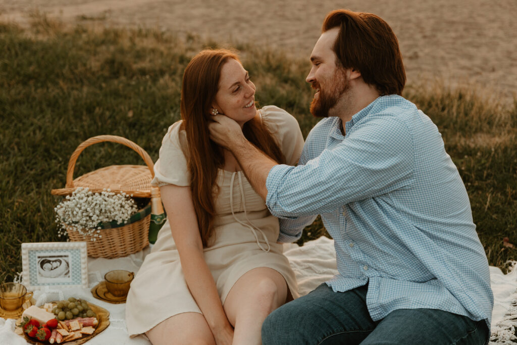 photo of couple on a beach picnic